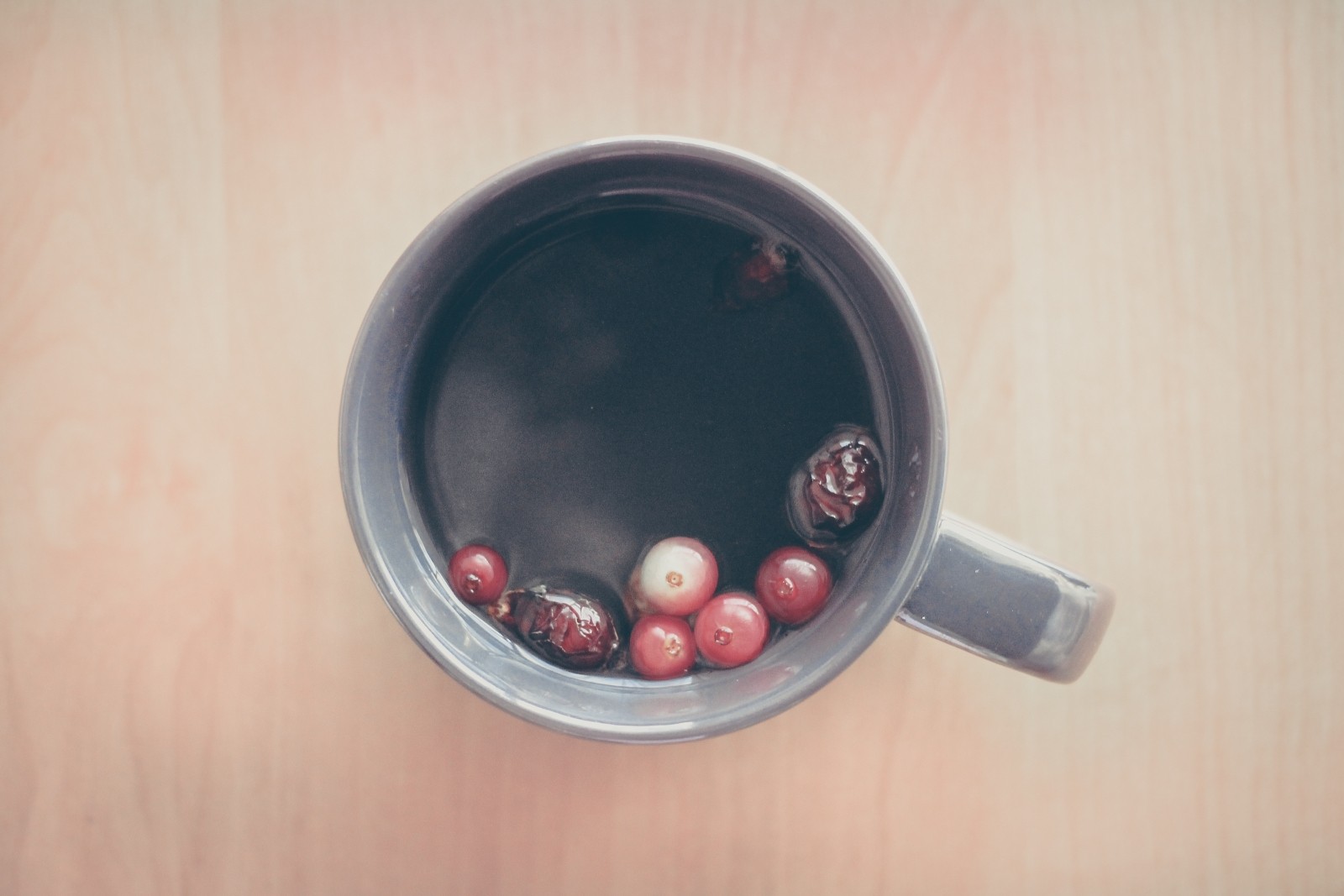 grey cup with tea and fall berries