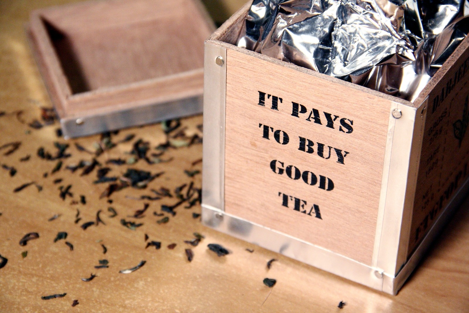 box of loose tea leaves with inscription it pays to buy good tea